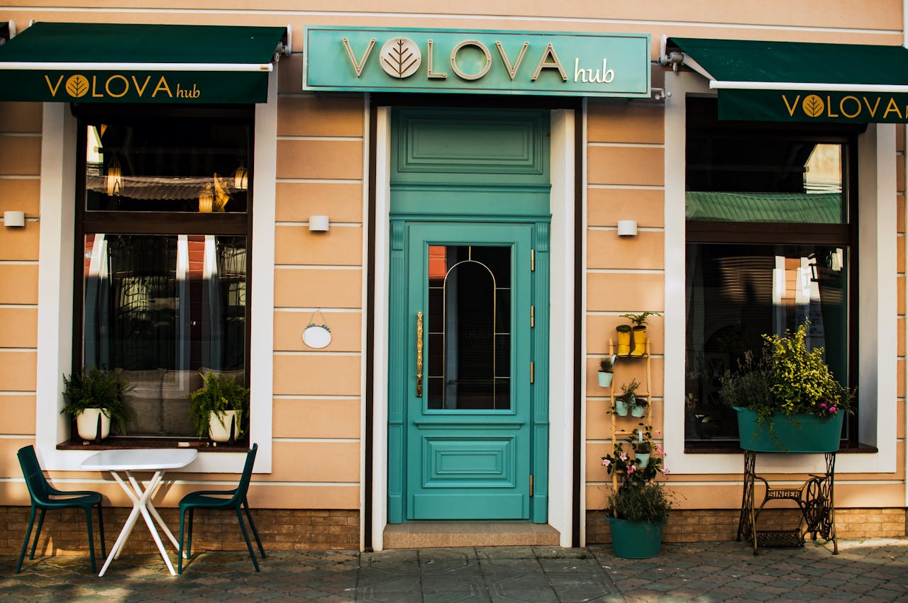 Top 10 Open-World Games with the Best Storylines A vibrant turquoise door of a stylish urban cafe with plants and seating in Ukraine.